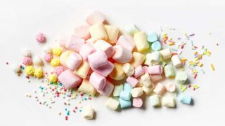 heap of various marshmallows and cake decorations, top view